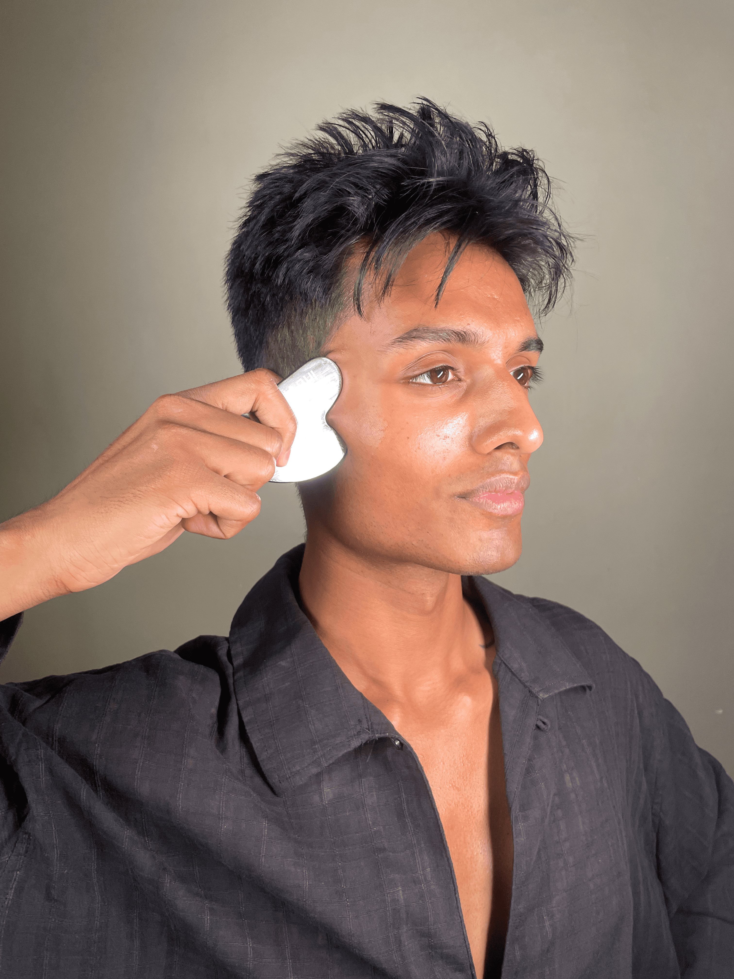 Gua Sha sculpting: contouring the cheekbone with a jade tool