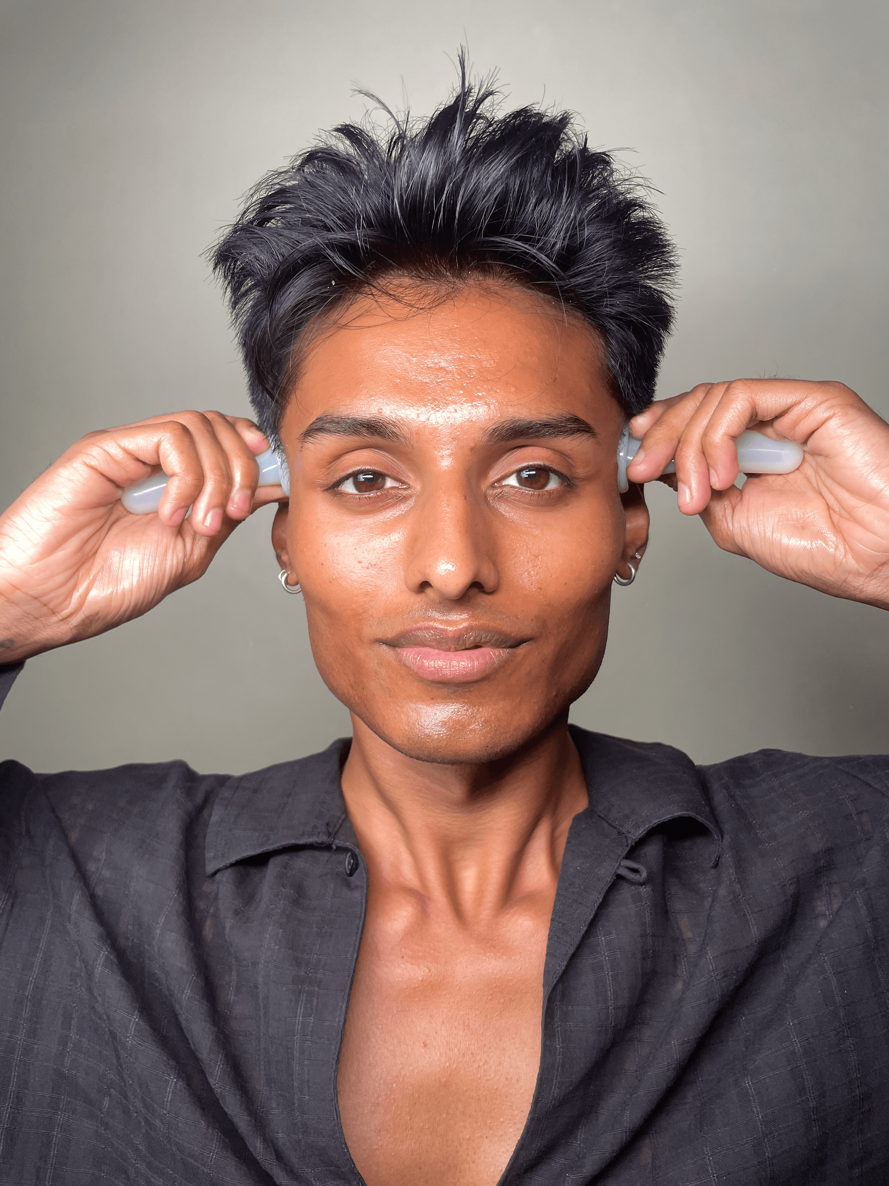 Dual Gua Sha: both tools sculpting the cheekbone area