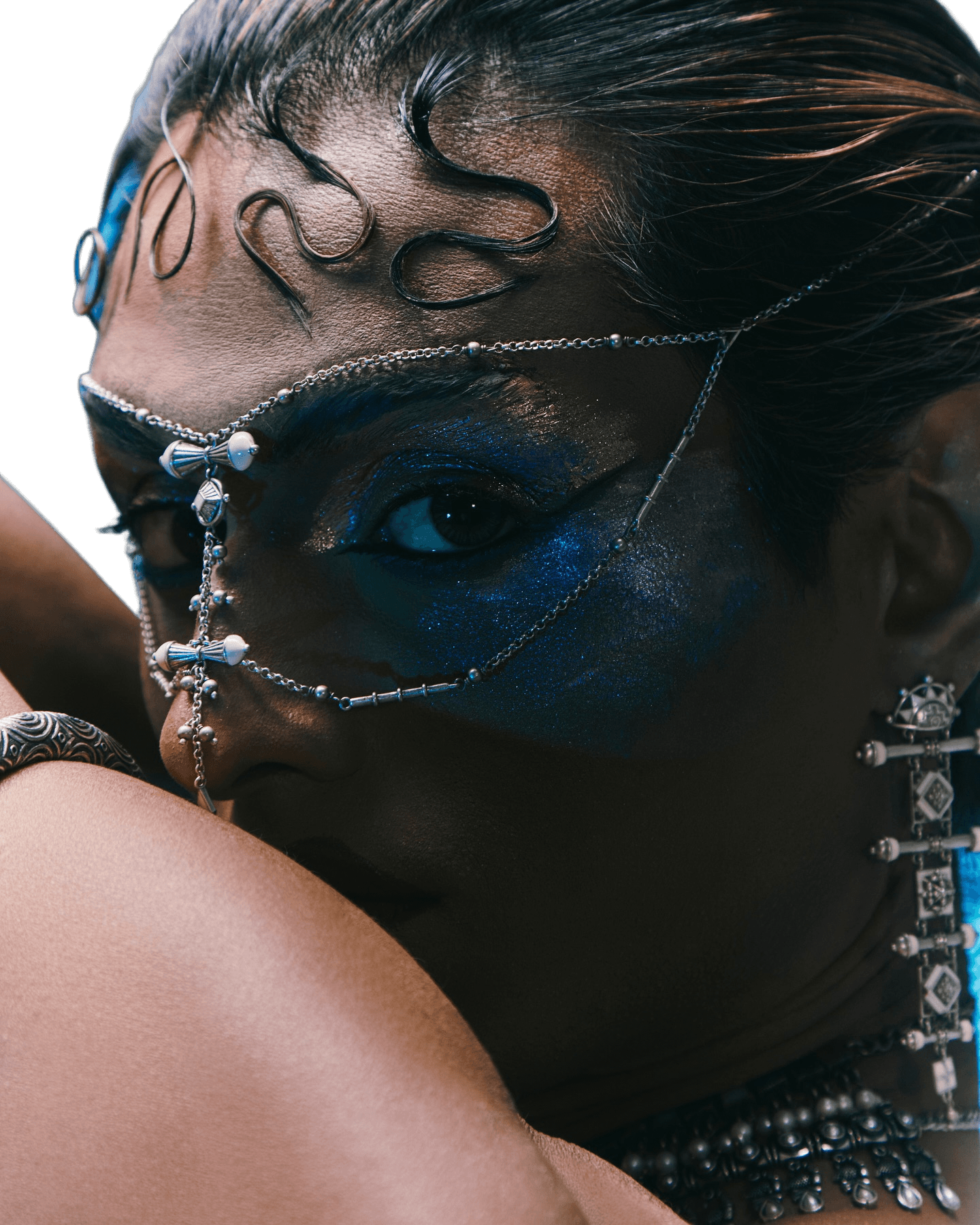 Avant-garde editorial portrait with face jewelry